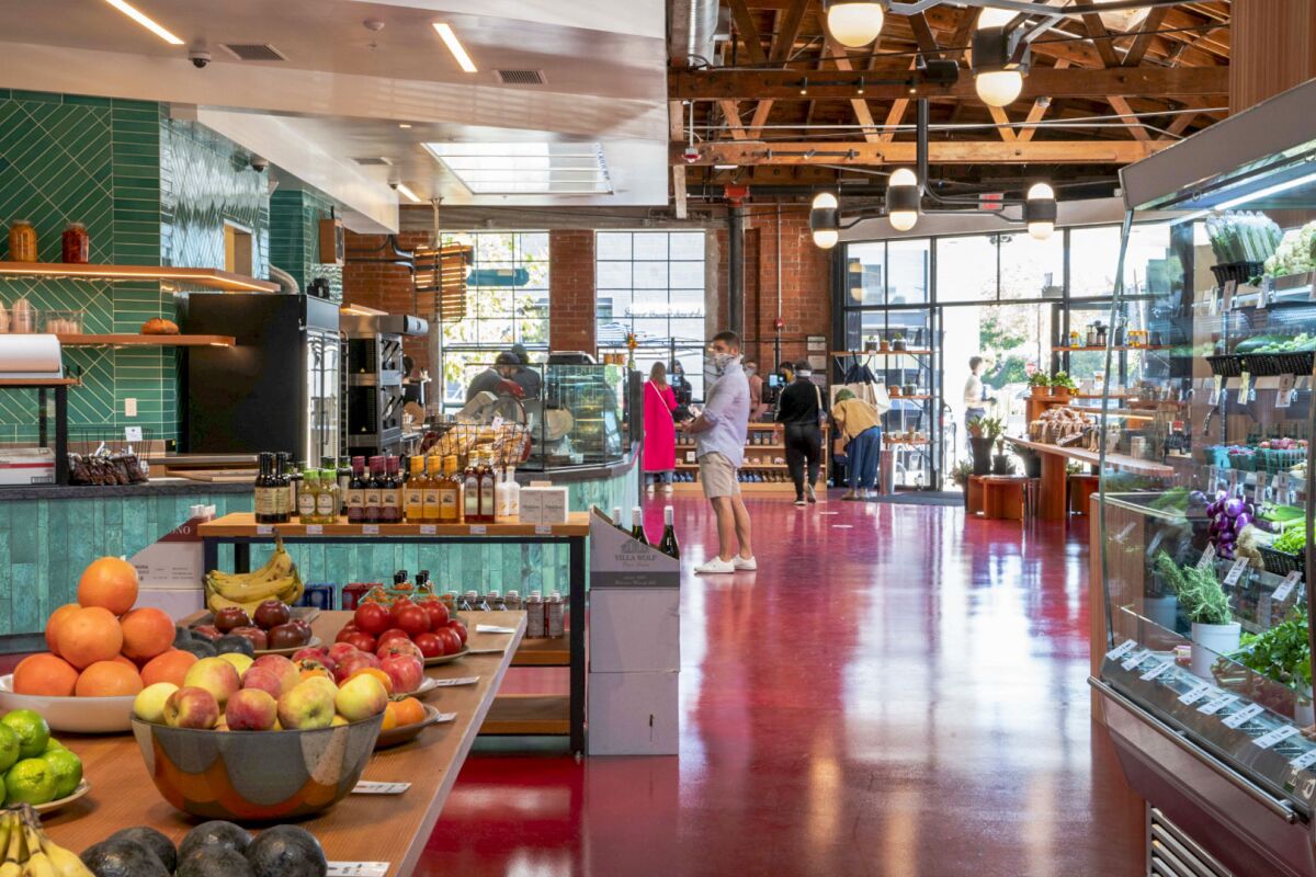 The interior of a building that has both grocery shelves and a coffee bar