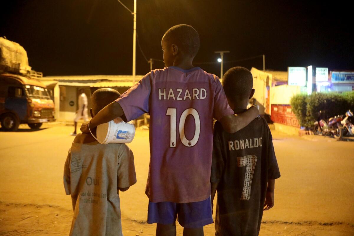 Street children enrolled in religious school, known as talibes, beg for money from passing traffic in Saint-Louis, Senegal.