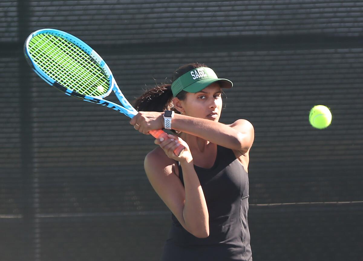 Kimi Reddy of Sage Hill hits a backhand in a doubles set against St. Margaret’s during a San Joaquin League match at Saddleback College on Wednesday.