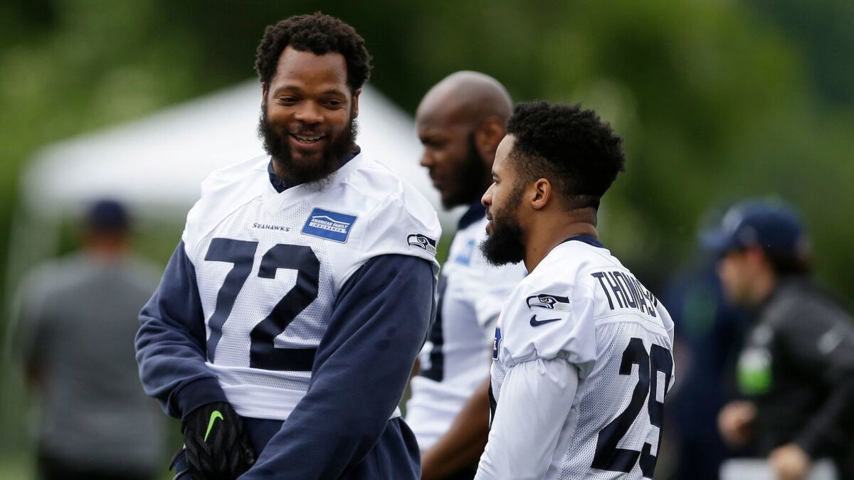 Michael Bennett, left, during practice with the Seattle Seahawks.