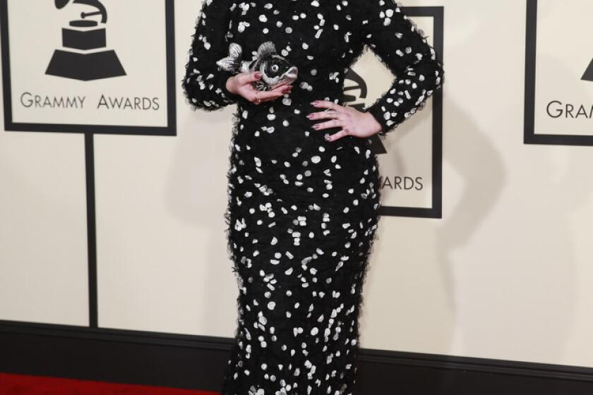 TV personality Kelly Osbourne wears a Christian Siriano gown to the 2015 Grammy Awards.