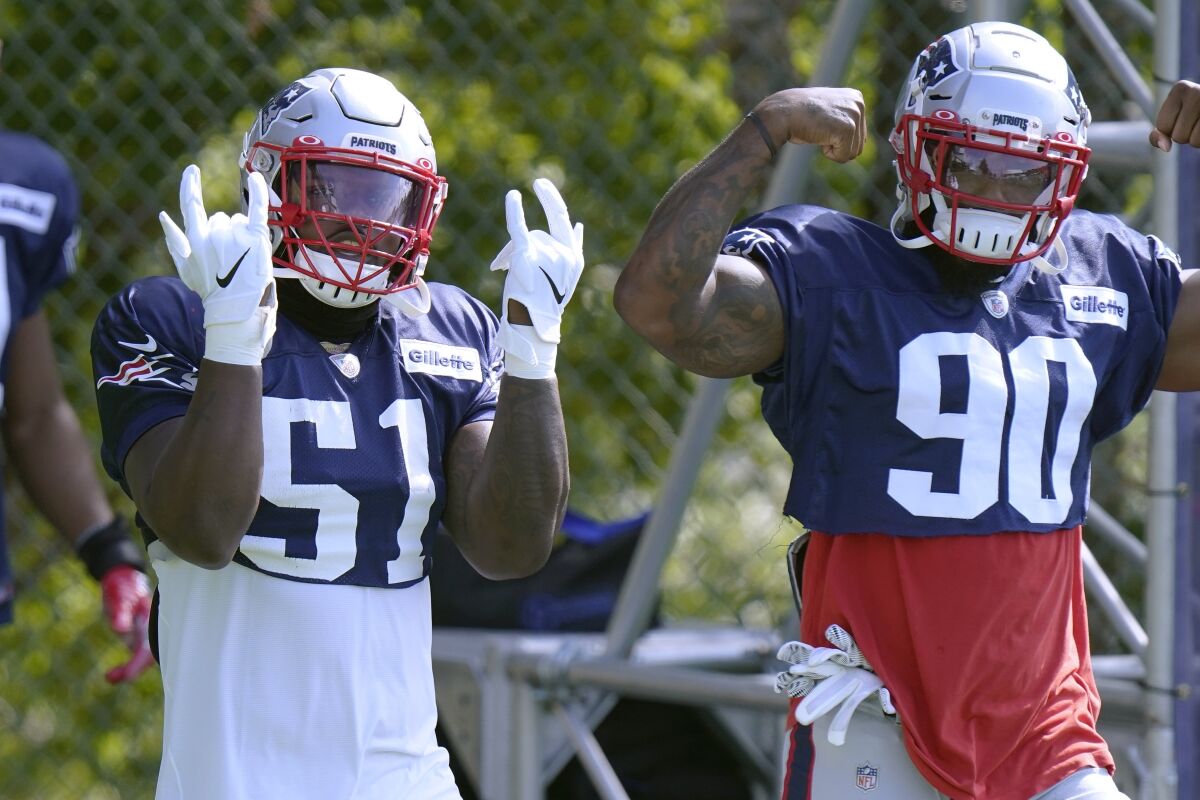 New England Patriots linebackers Ja'Whaun Bentley (51) and Shilique Calhoun (90) step onto the field for an NFL football training camp practice, Monday, Aug. 24, 2020, in Foxborough, Mass. (AP Photo/Steven Senne, Pool)