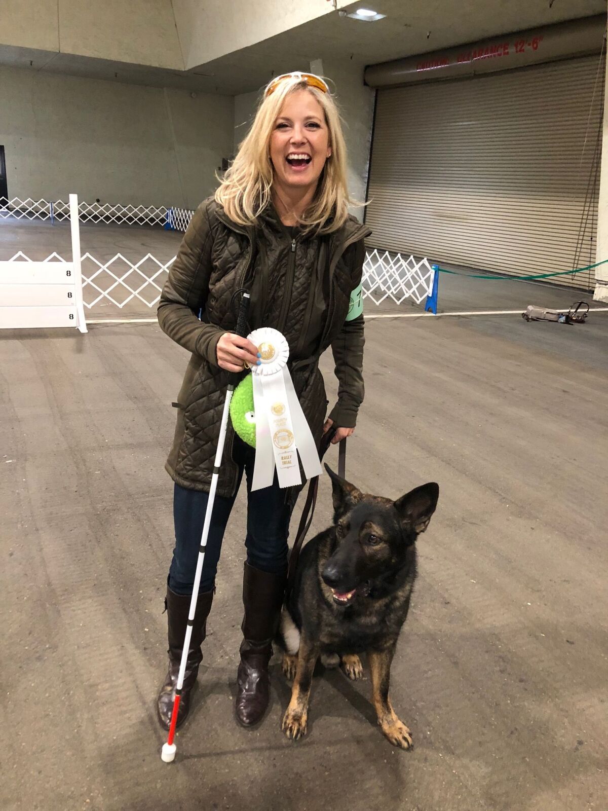 Amy Dixon of Encinitas with her guide dog, Woody, at a rally event in Del Mar in 2018.