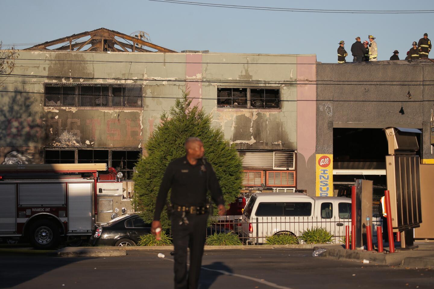 Firefighters and police work at the scene of an overnight fire on Dec. 3, 2016 in Oakland, California.