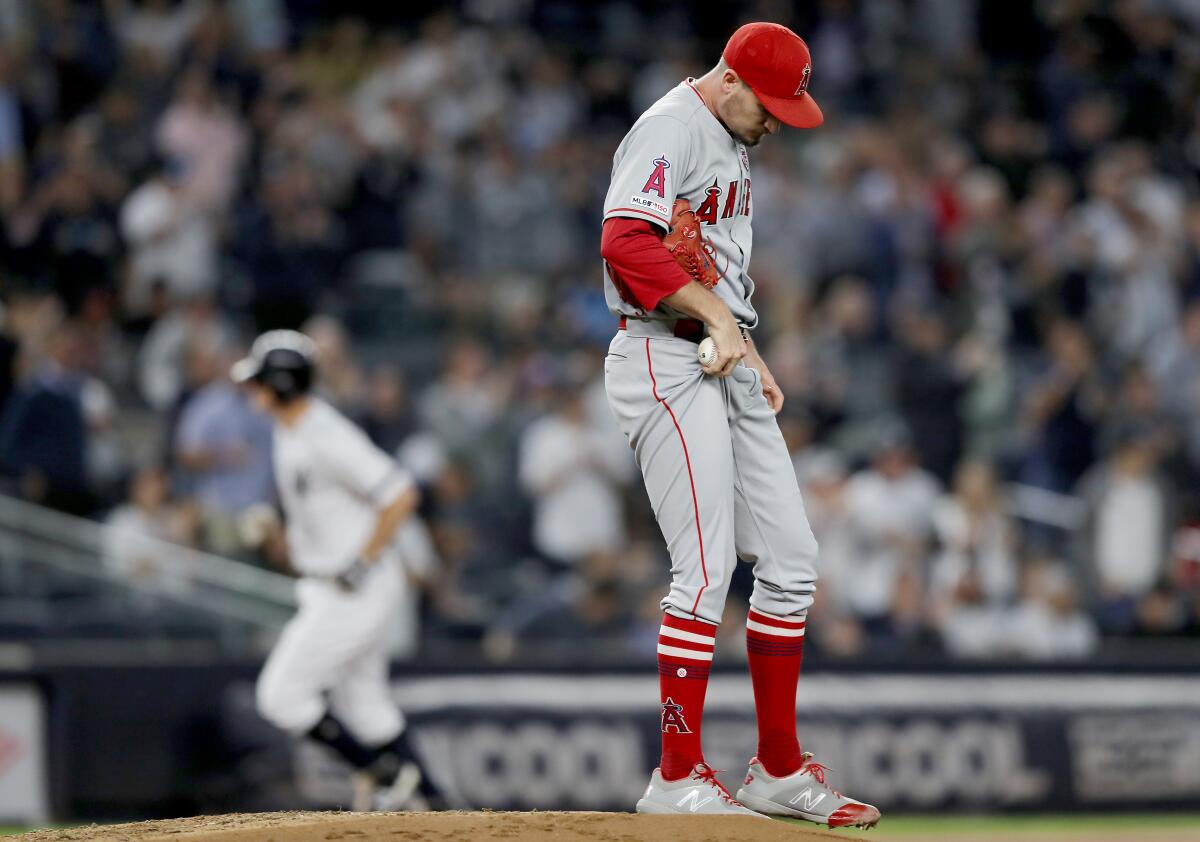 Angels pitcher Andrew Heaney reacts as New York Yankees' DJ LeMahieu rounds third base after his three-run home run in the second inning on Thursday in New York.