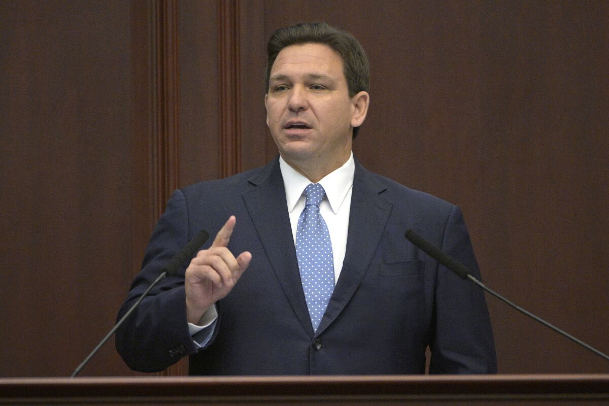 FILE - Florida Gov. Ron DeSantis addresses a joint session of a legislative session, Jan. 11, 2022, in Tallahassee, Fla. Democratic and Republican governors are taking vastly different approaches to addressing the ongoing pandemic in their state of the state speeches. (AP Photo/Phelan M. Ebenhack, File)