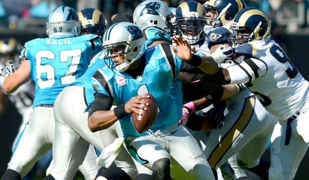 Panthers quarterback Cam Newton scrambles away the Rams defense during Carolina's 30-15 victory over St. Louis on Sunday.