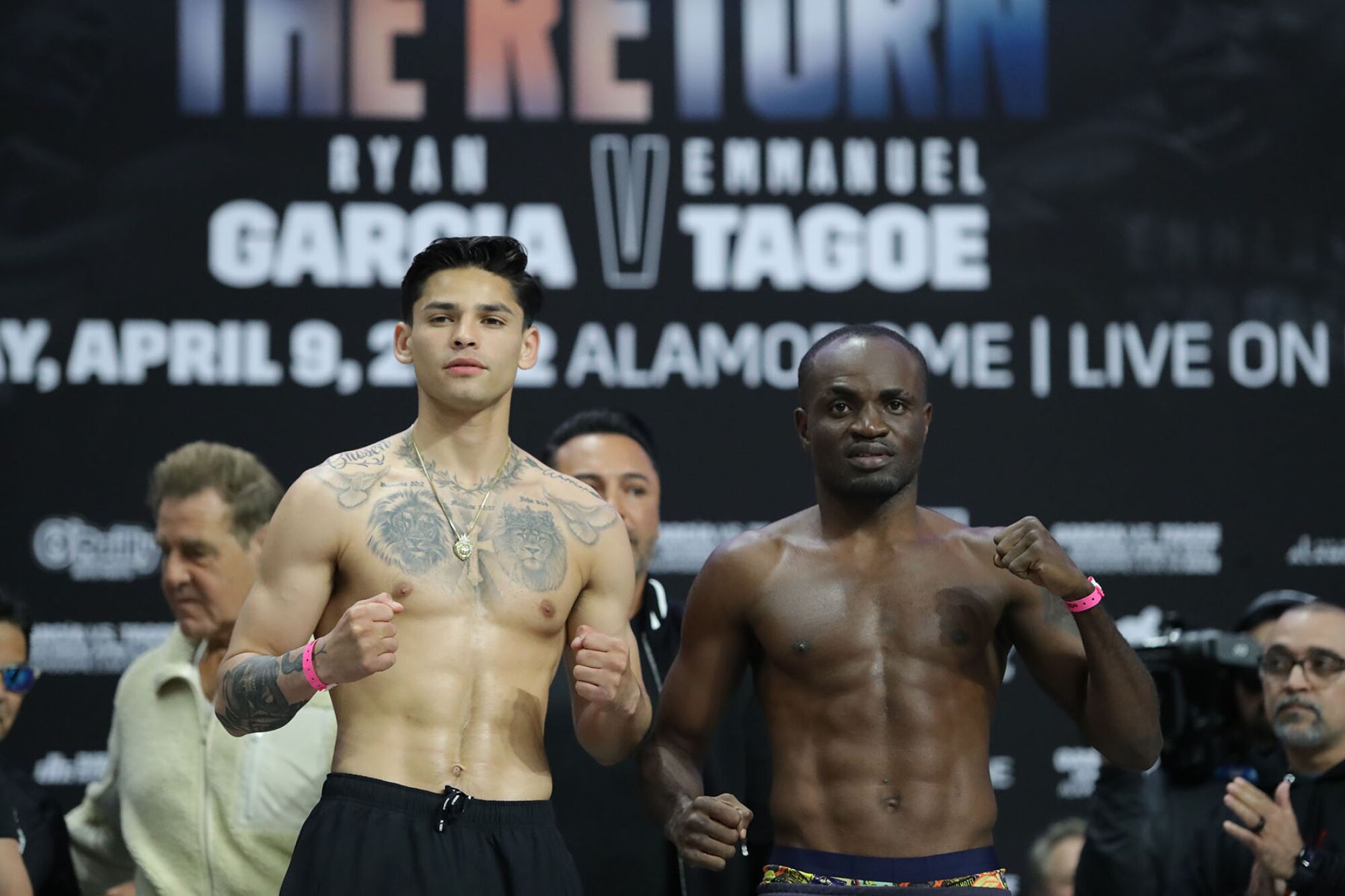 Ryan Garcia and Emannuel Tagoe face a crowd and hold up their fists.