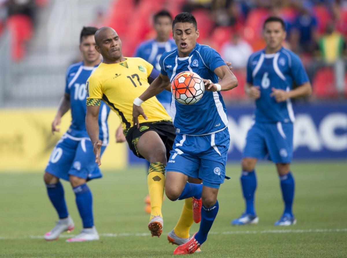 Darwin Ceren of El Salvador runs with the ball in front of Jamaica's Rudolph Austin during a CONCACAF Golf Cup match Tuesday in Toronto. Jamaica beat El Salvador, 1-0.