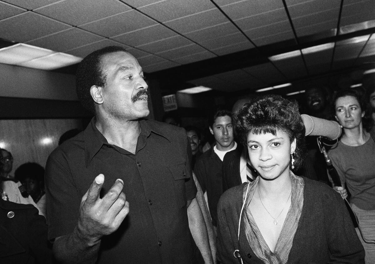 Jim Brown answers questions outside a Los Angeles courtroom in March 1985.