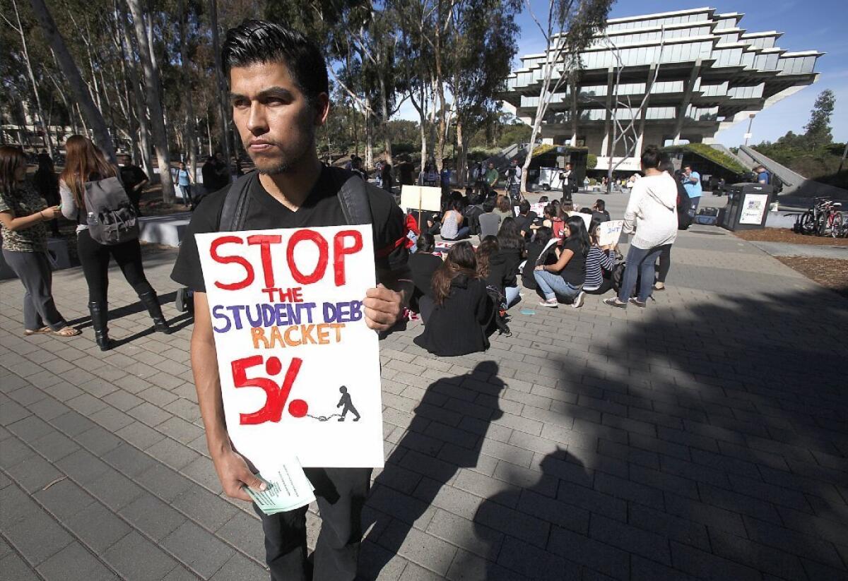 Several hundred UC San Diego students gathered in front of Geisel Library to protest a proposed hike in tuition of up to 5% for the next five years on Tuesday.