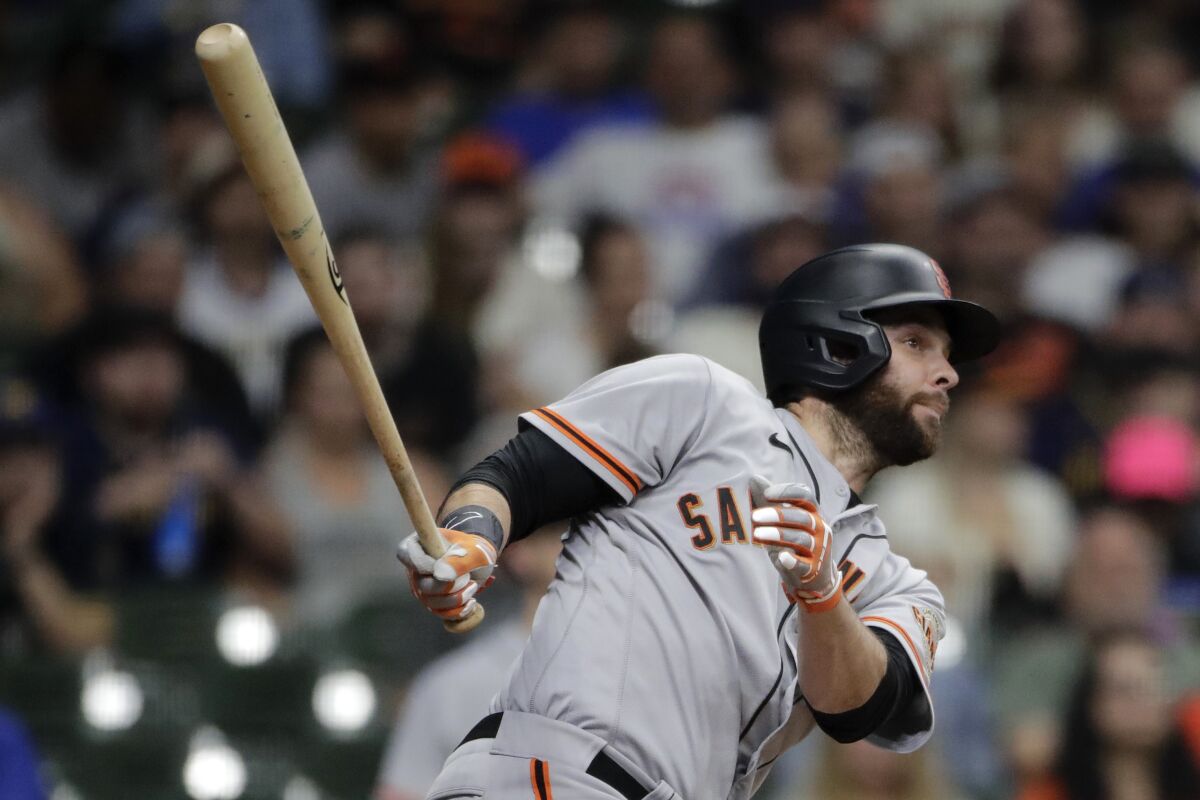 San Francisco Giants' Brandon Belt watches his two-run home run during the 11th inning of the team's baseball game against the Milwaukee Brewers on Saturday, Aug. 7, 2021, in Milwaukee. (AP Photo/Aaron Gash)