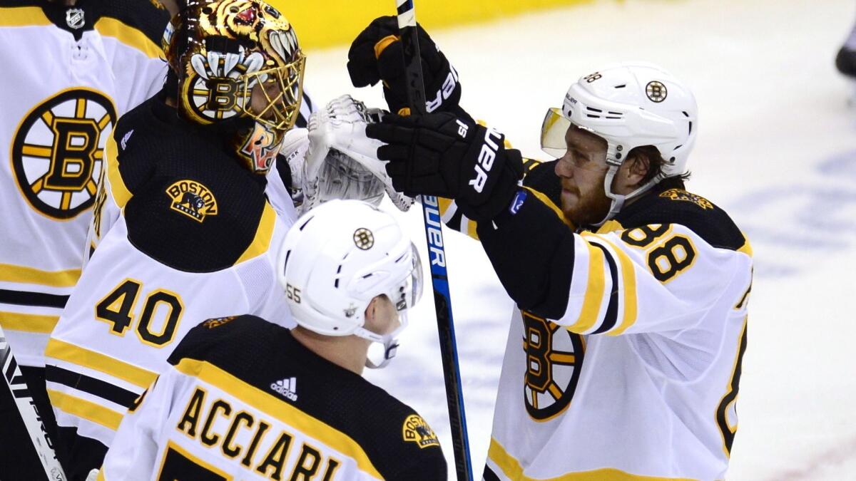 Bruins right wing David Pastrnak (88) celebrates with goaltender Tuukka Rask after defeating the Maple Leafs on Sunday.