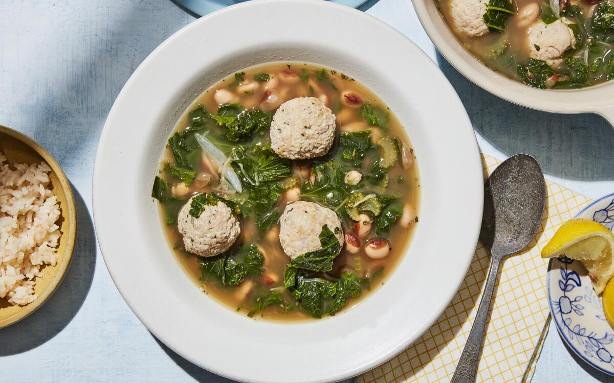 Rosemary adds an herbaceous aroma to simple pork meatballs cooked in a savory broth with beans and wilted mustard greens.