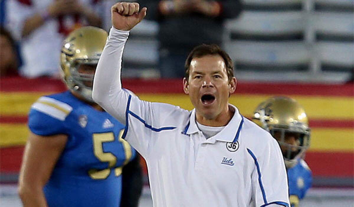 UCLA Coach JIm Mora watches his team warm up before playing USC last season.
