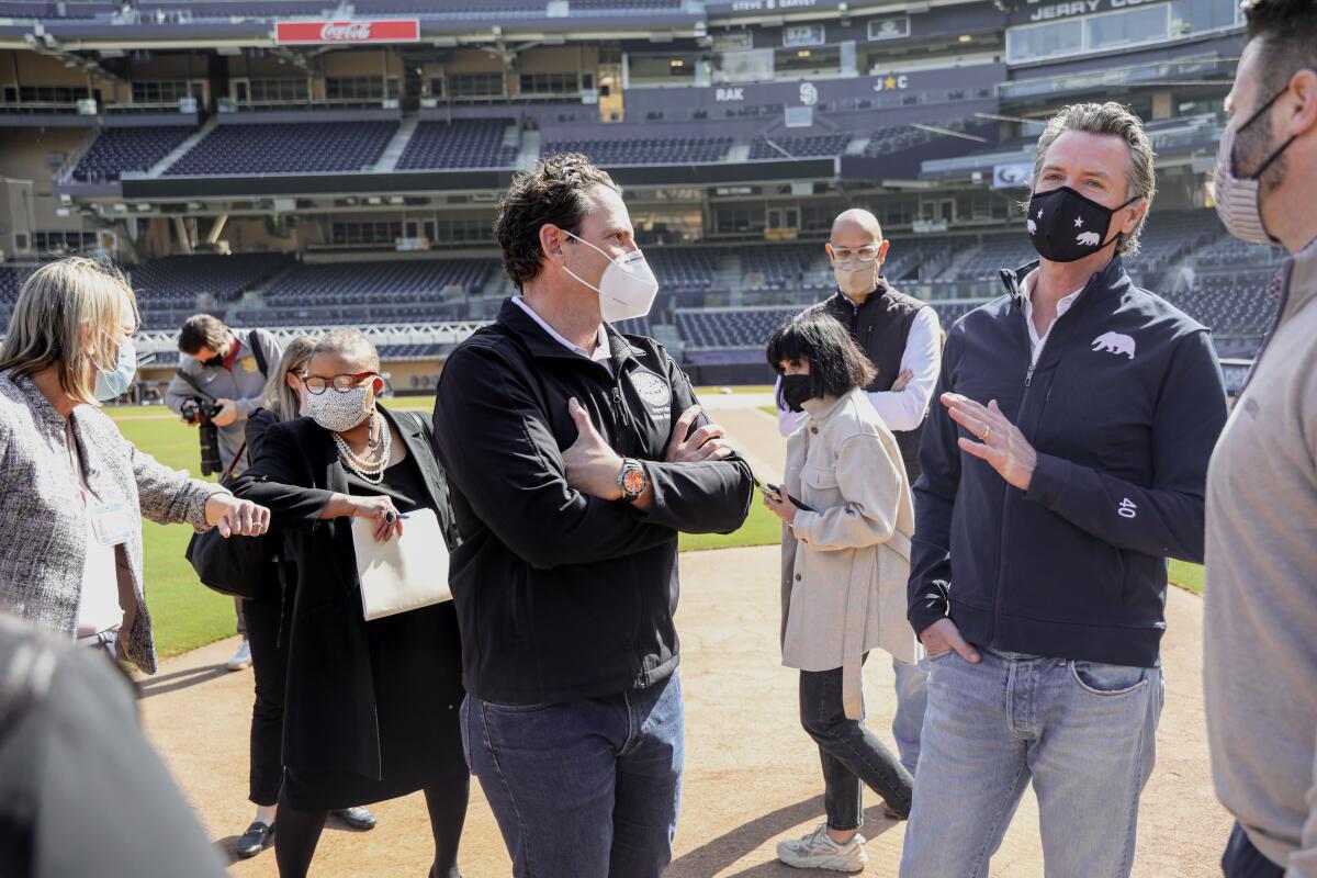 California Governor Gavin Newsom speaks to officials before a press conference at Petco Park 