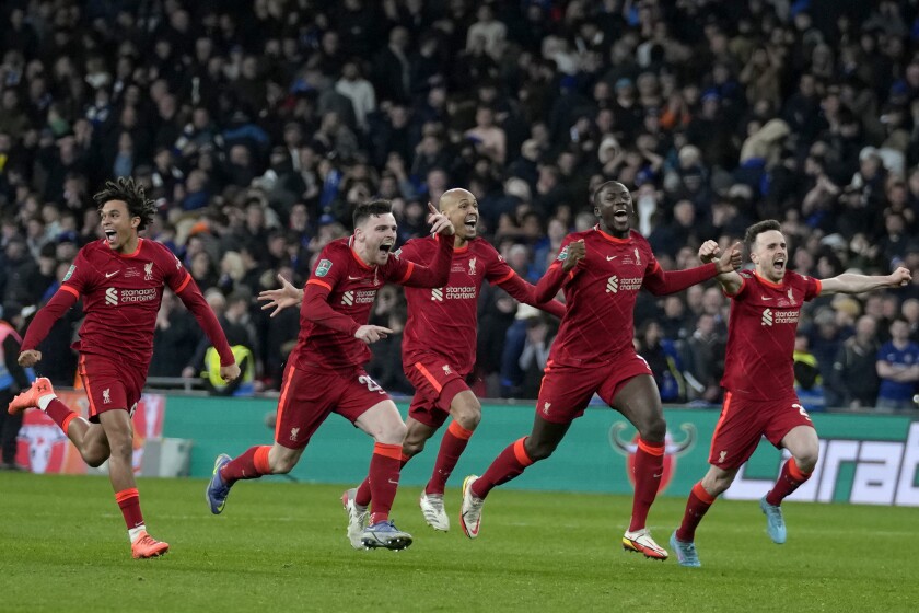 Liverpool players celebrate after winning the English League Cup final soccer match between Chelsea and Liverpool at Wembley stadium in London, Sunday, Feb. 27, 2022. Liverpool won a penalty shootout 11-10 after the match ended tied 0-0. (AP Photo/Alastair Grant)
