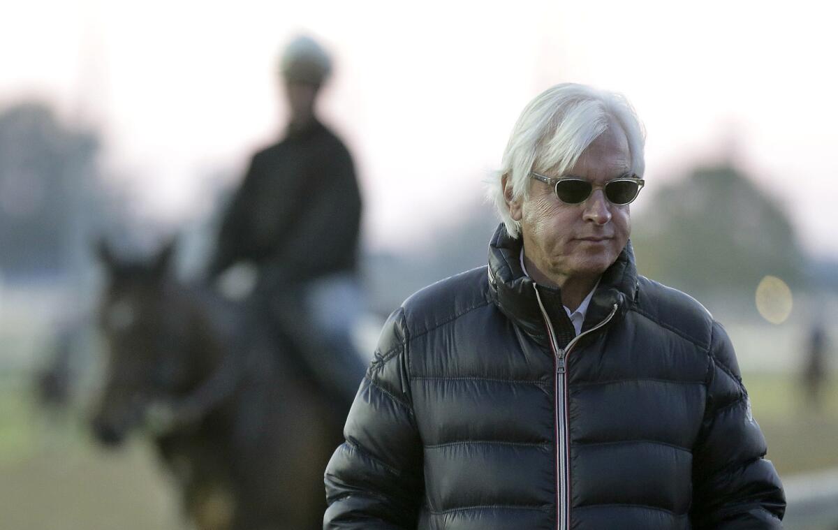 Trainer Bob Baffert watches horses work out at Churchill Downs. Baffert has trained two of the Kentucky Derby favorites, Dortmund and American Pharoah.