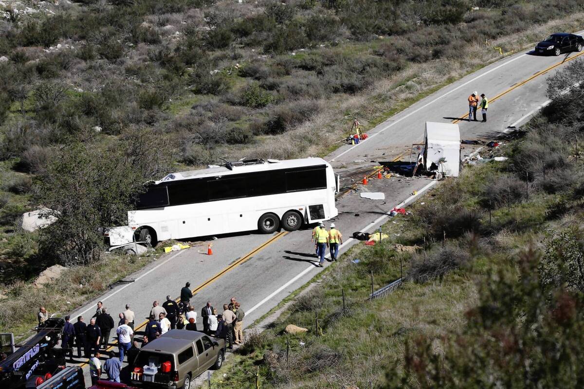 Investigators look over the scene where a tour bus crashed on California Highway 38 near Yucaipa. Seven people were killed. The U.S. Department of Transportation is cracking down on unsafe bus companies.