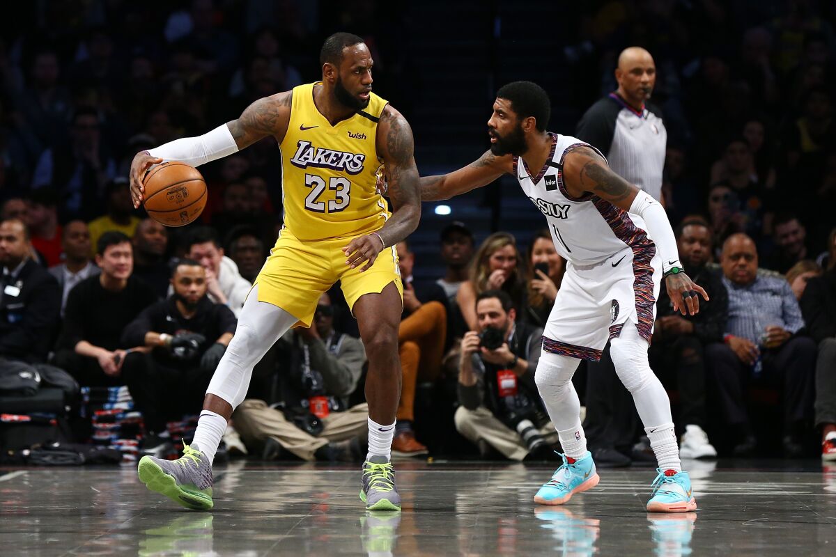 Nets guard Kyrie Irving defends against Lakers forward LeBron James during the first half of a game Jan. 23, 2020, at Barclays Center.