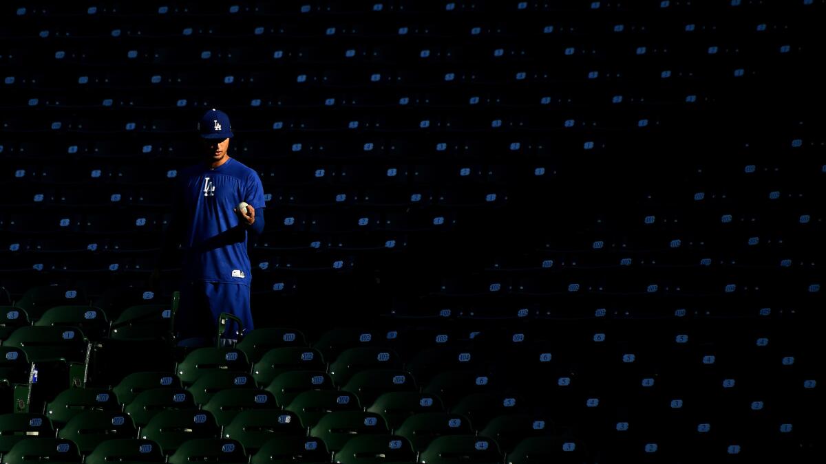 Dodgers pitcher Yu Darvish feteches a ball before Game 4 of the NLCS at Wrigley Field.