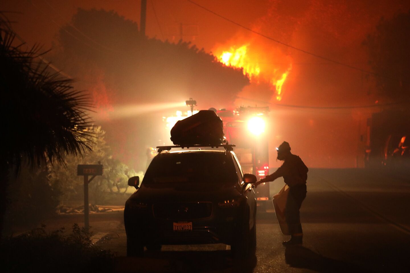 A resident packs up his car as the Woolsey fire bears down on Dume Drive in Malibu.