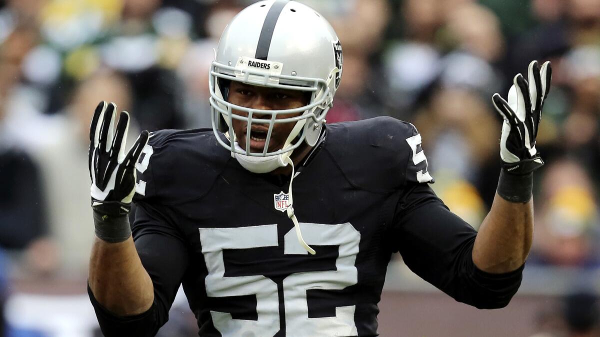 Defensive end Khalil Mack (52) and the Raiders slowed down but could not beat the Packers on Sunday.