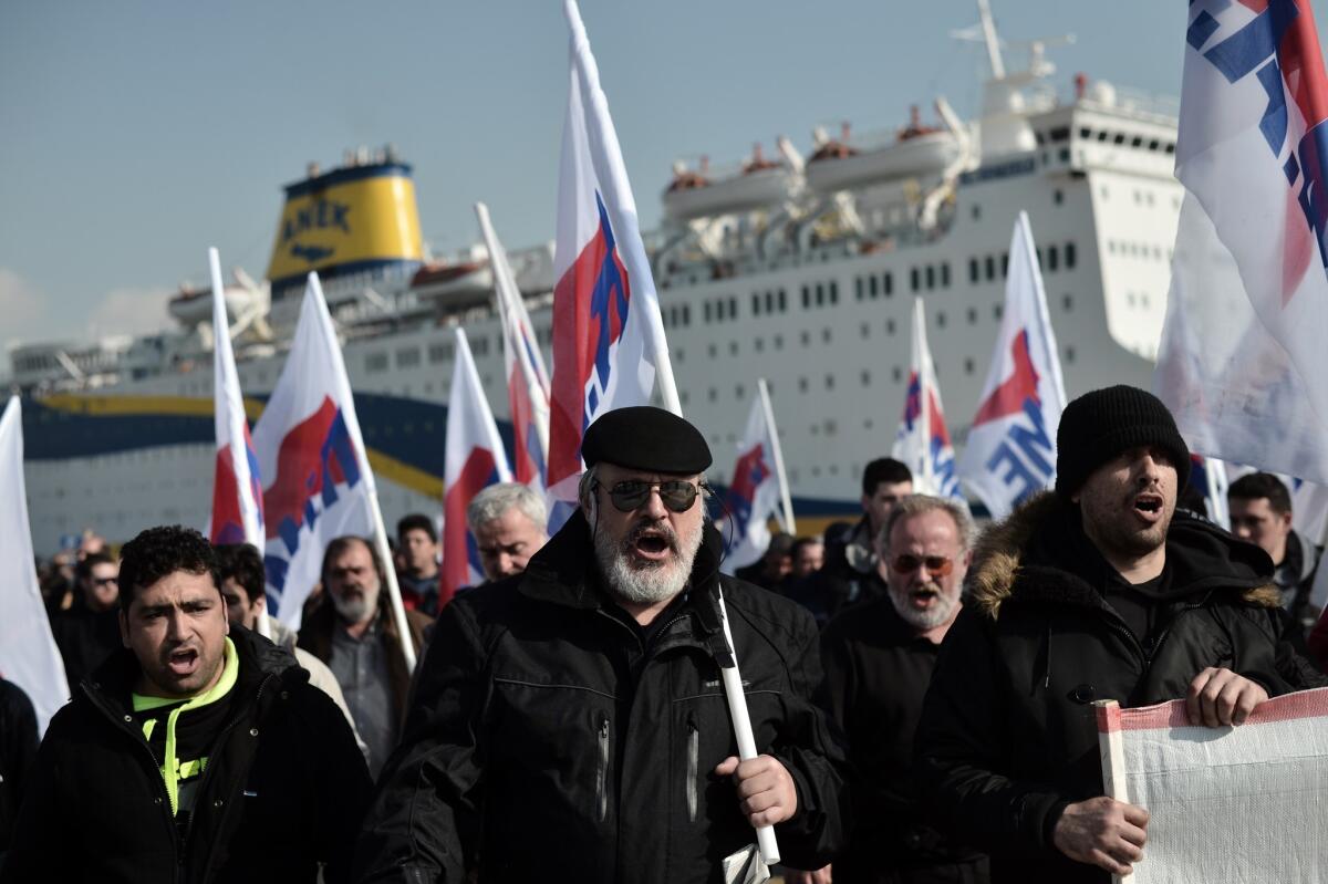 Union members protest at Greece's main port, Piraeus, near Athens, as the government invokes emergency powers to end a crippling seamen's strike.