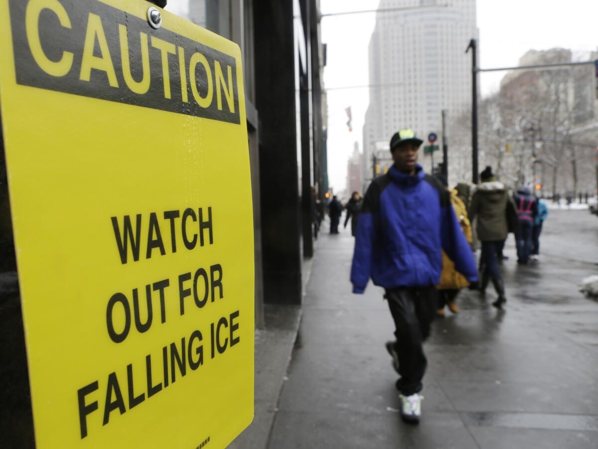 A sign warns pedestrians of falling ice near New York's City Hall.