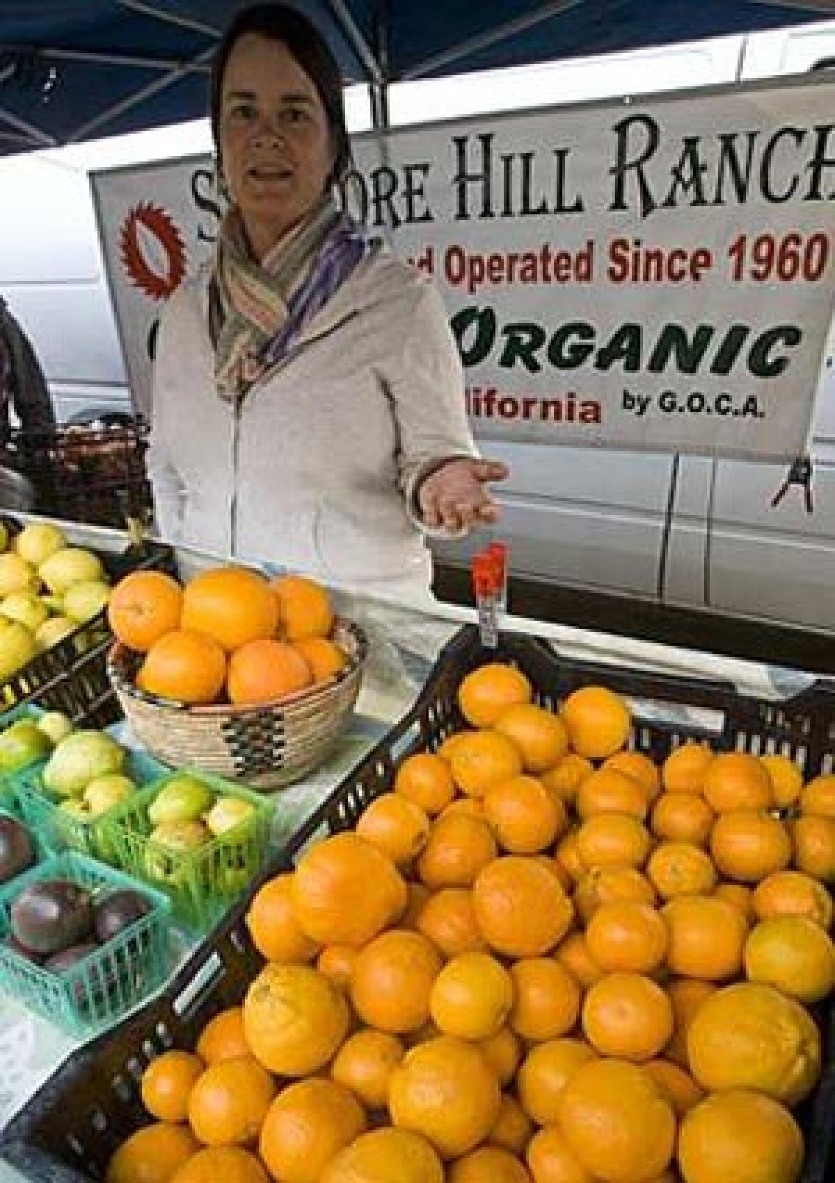 Jeanne Stehly of Sycamore Hill Ranch, from Fillmore, points to her Pixie mandarins, at the Santa Monica Organic farmers market. She just started bringing this variety; the fruits are very good, and naturally low in acidity.