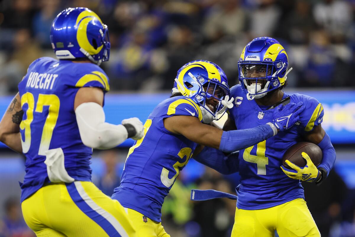 Rams defensive back Jordan Fuller is congratulated by a teammate after intercepting a pass.
