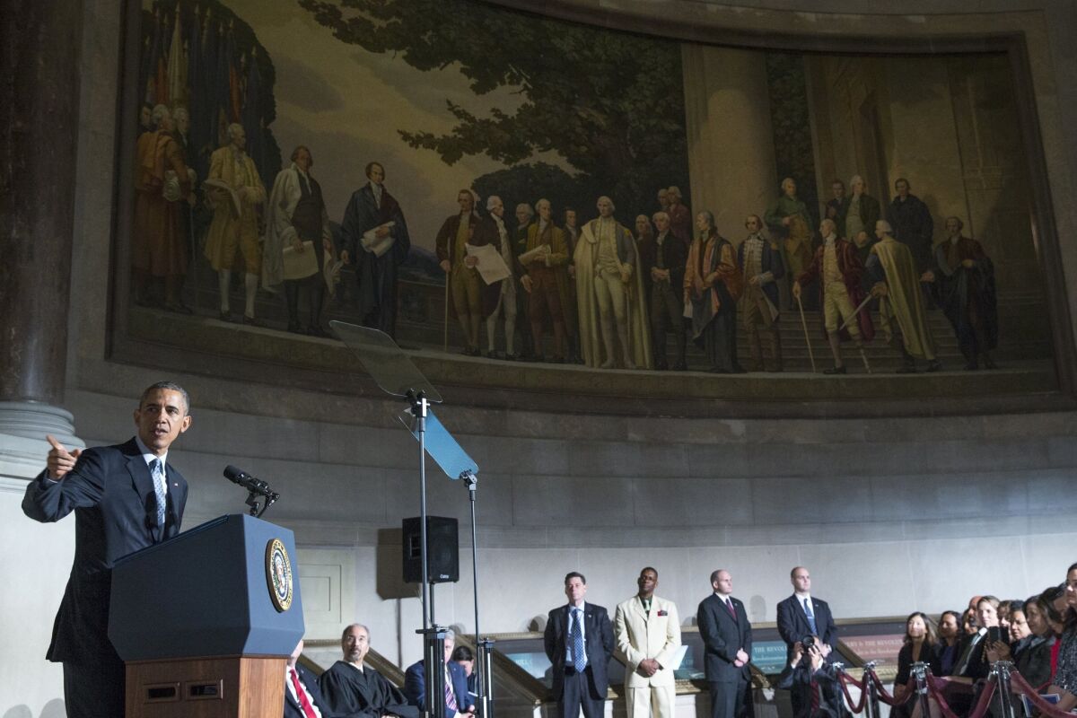 President Barack Obama speaks during a naturalization ceremony at the National Archives in Washington, Tuesday, Dec. 15, 2015. The president described immigration as the nation's oldest tradition and part of what makes the country exceptional, as he sought to draw a contrast between those who want to seal the borders and those seeking to escape hardships and persecution. (AP Photo/Evan Vucci)