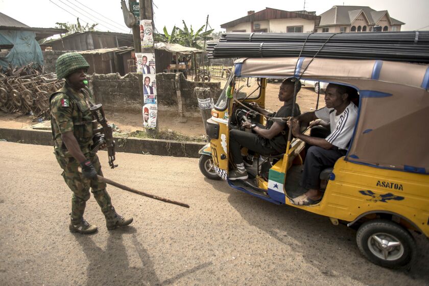 A Nigerian soldier control the traffic in Aba, in a pro-Biafra separatists zone, southeastern Nigeria, on February 15, 2019. - The southeastern Nigeria region, that has long complained it has been marginalised by successive governments and military regimes since the end of the civil war in 1970, has been largely calm in the run-up to the election, but there has been a noticeable increase in military and police checkpoints, AFP correspondents said. (Photo by CRISTINA ALDEHUELA / AFP) (Photo credit should read CRISTINA ALDEHUELA/AFP/Getty Images) ** OUTS - ELSENT, FPG, CM - OUTS * NM, PH, VA if sourced by CT, LA or MoD **