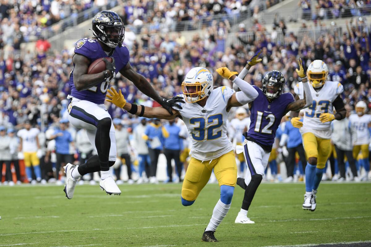 Baltimore Ravens running back Latavius Murray (28) scores a touchdown past Chargers defensive back Alohi Gilman.