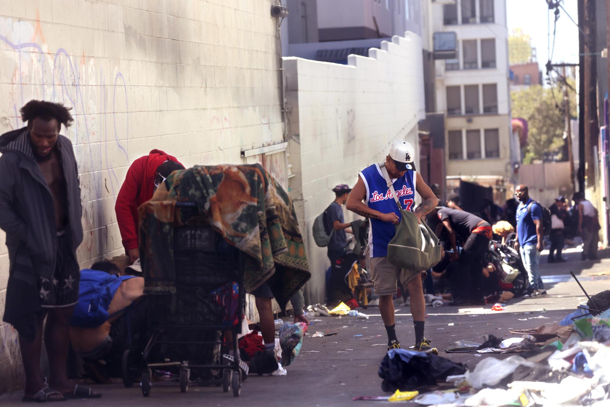 People gather in an alley next to MacArthur Park. 