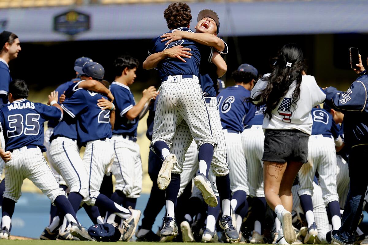 Birmingham High baseball players celebrate on the field at Dodger Stadium after defeating Carson 3-1 in City Section final.