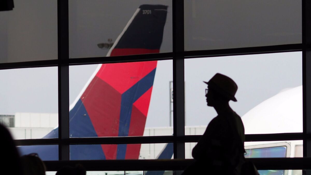 A passenger waits for a Delta Airlines flight.