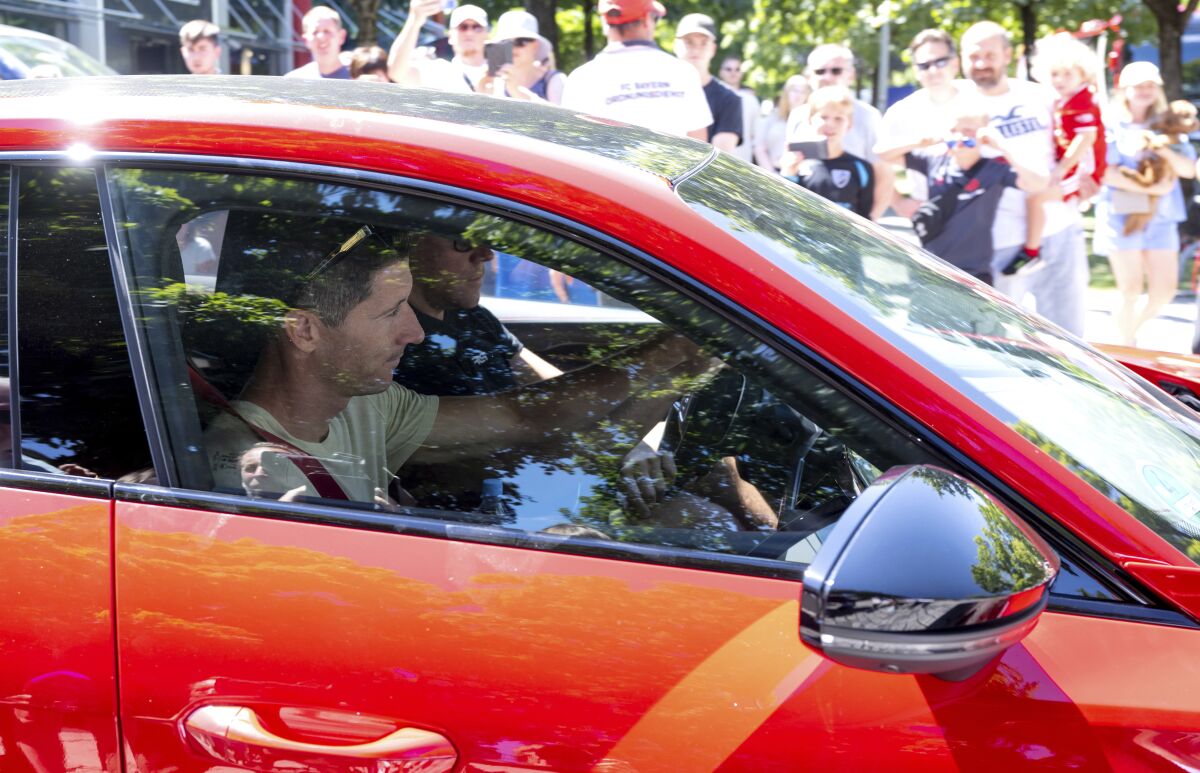 Robert Lewandowski leaves FC Bayern Munich training grounds in his car after training, in Munich, Germany, Saturday, July 16, 2022. Barcelona is set to sign Poland striker Robert Lewandowski from Bayern Munich after the clubs reached an agreement in principle for his transfer, a person with knowledge of the negotiations tells The Associated Press. The person, who spoke under anonymity because he was not allowed to speak publicly about the deal, said that the official confirmation of the deal could come on Saturday. (Sven Hoppe/dpa via AP)