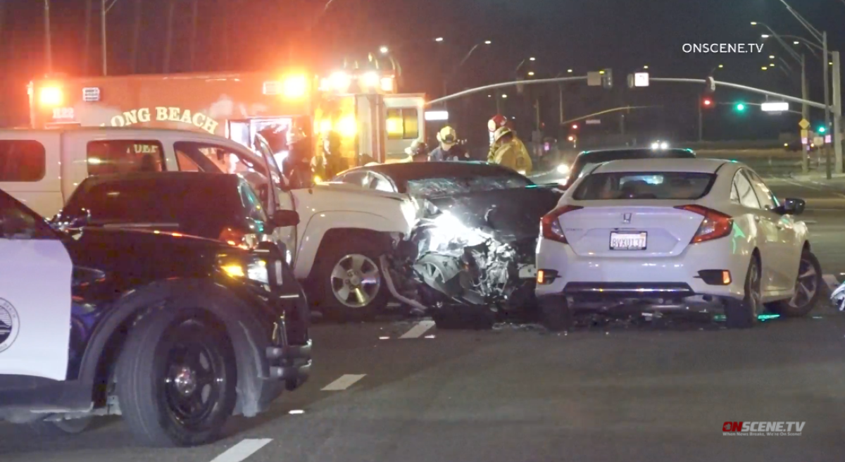 An ambulance is shown next to wrecked cars.