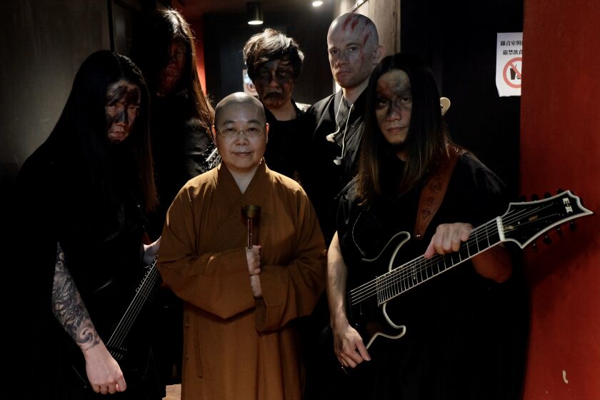 This picture taken on December 3, 2020 shows members of Taiwanese death metal band 'Dharma' posing for photographs during a rehearsal in Taipei. (Photo by Sam Yeh / AFP) (Photo by SAM YEH/AFP via Getty Images)