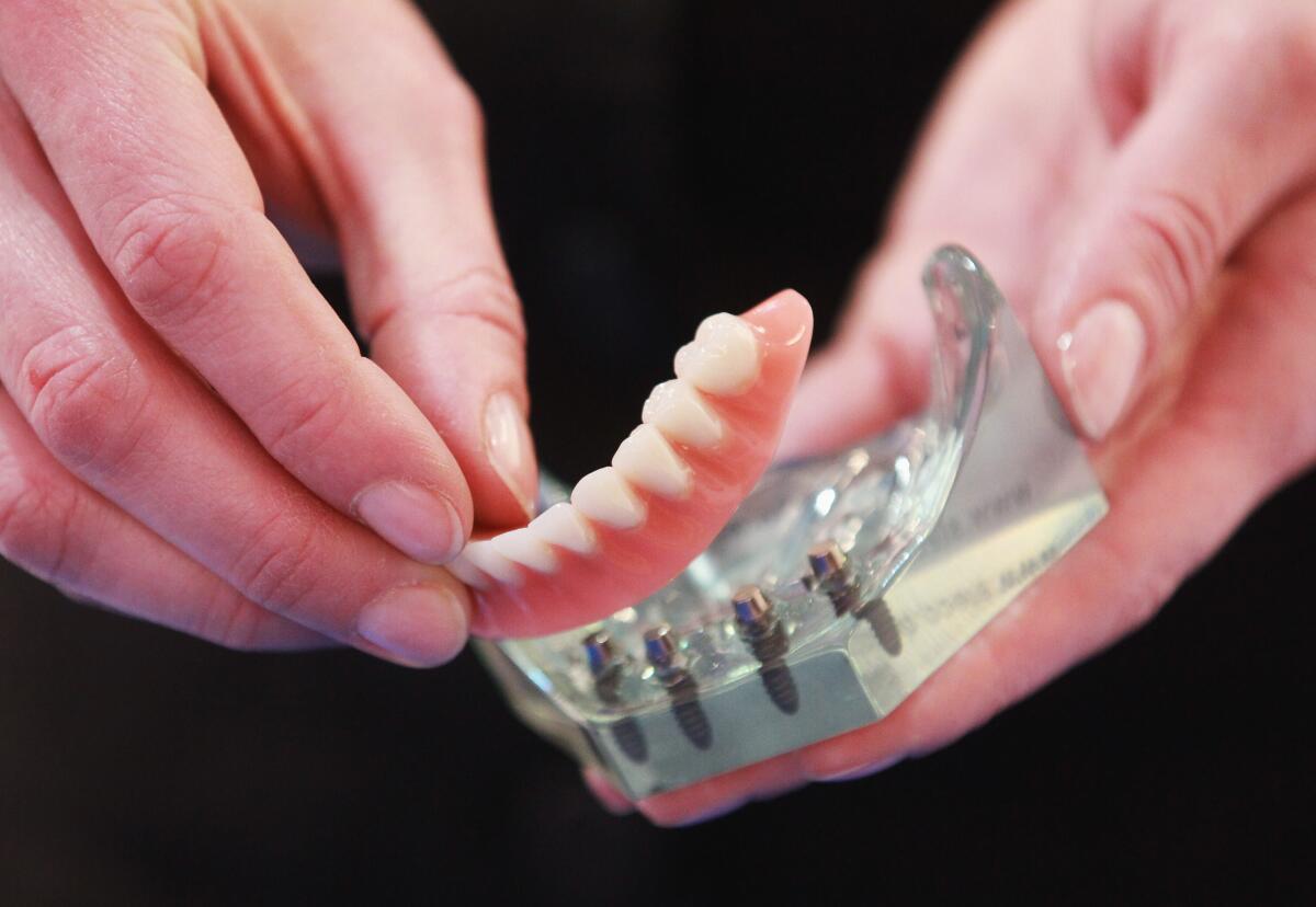 Magnetic false teeth are seen during a trade fair in Hamburg, Germany.