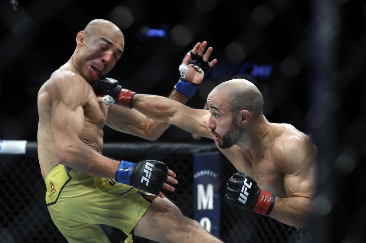 LAS VEGAS, NEVADA - DECEMBER 14: Marlon Moraes (R) connects with a punch on Jose Aldo in their bantamweight fight during UFC 245 at T-Mobile Arena on December 14, 2019 in Las Vegas, Nevada. Moraes won teh fight by split decision. (Photo by Steve Marcus/Getty Images) ** OUTS - ELSENT, FPG, CM - OUTS * NM, PH, VA if sourced by CT, LA or MoD **
