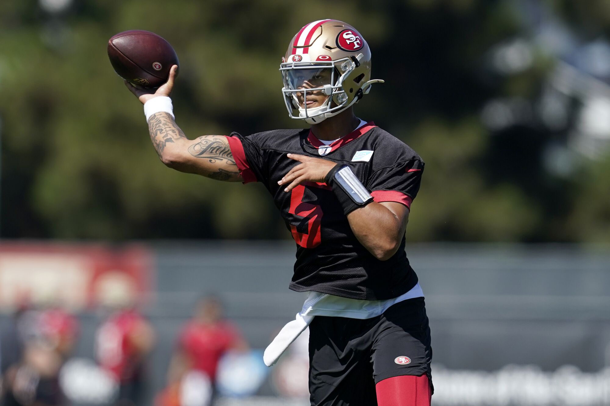 San Francisco 49ers' Trey Lance takes part in drills at practice.