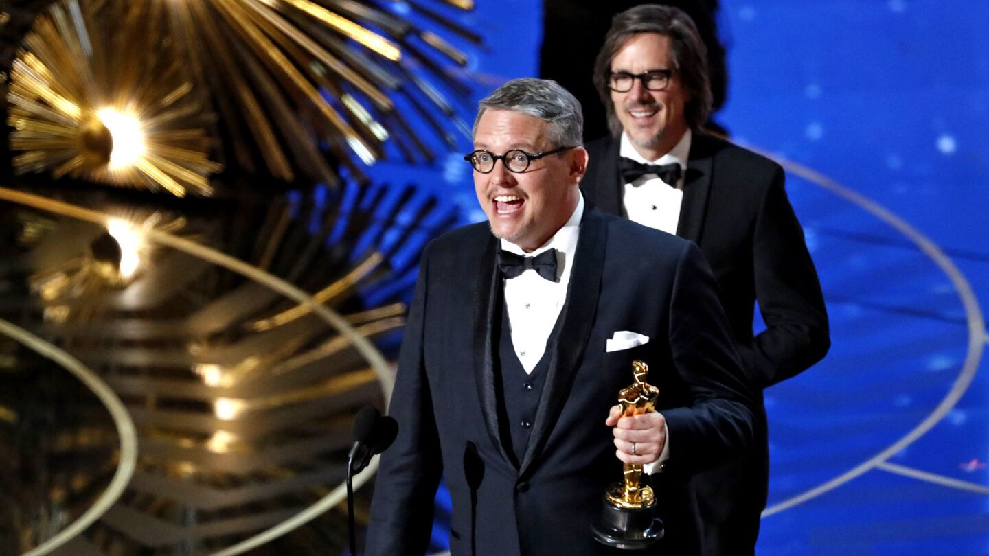 Adam McKay, front, and Charles Randolph with their Oscar for Best Adapted Screenplay.