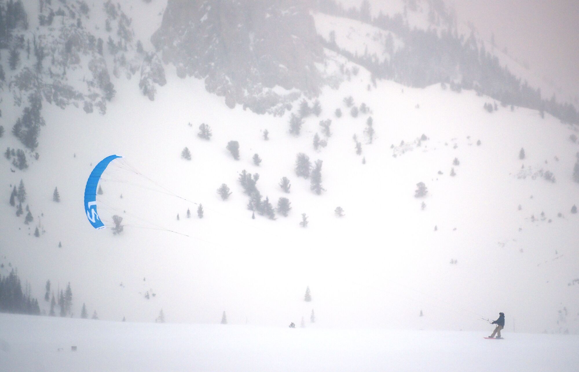 A thrill seeker goes kite snowboarding in Mammoth Mountain on Monday.