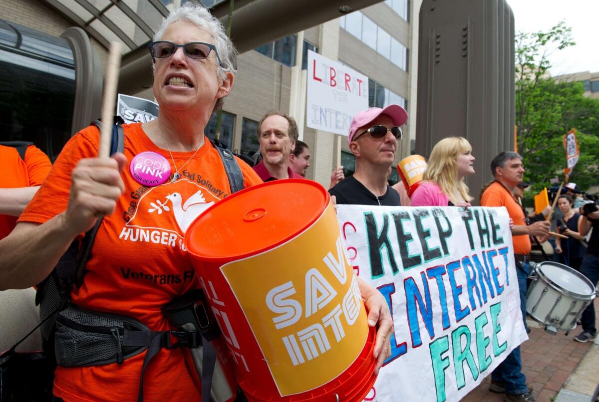 Protesters hold a rally in favor of net neutrality outside the Federal Communications Commission in May.