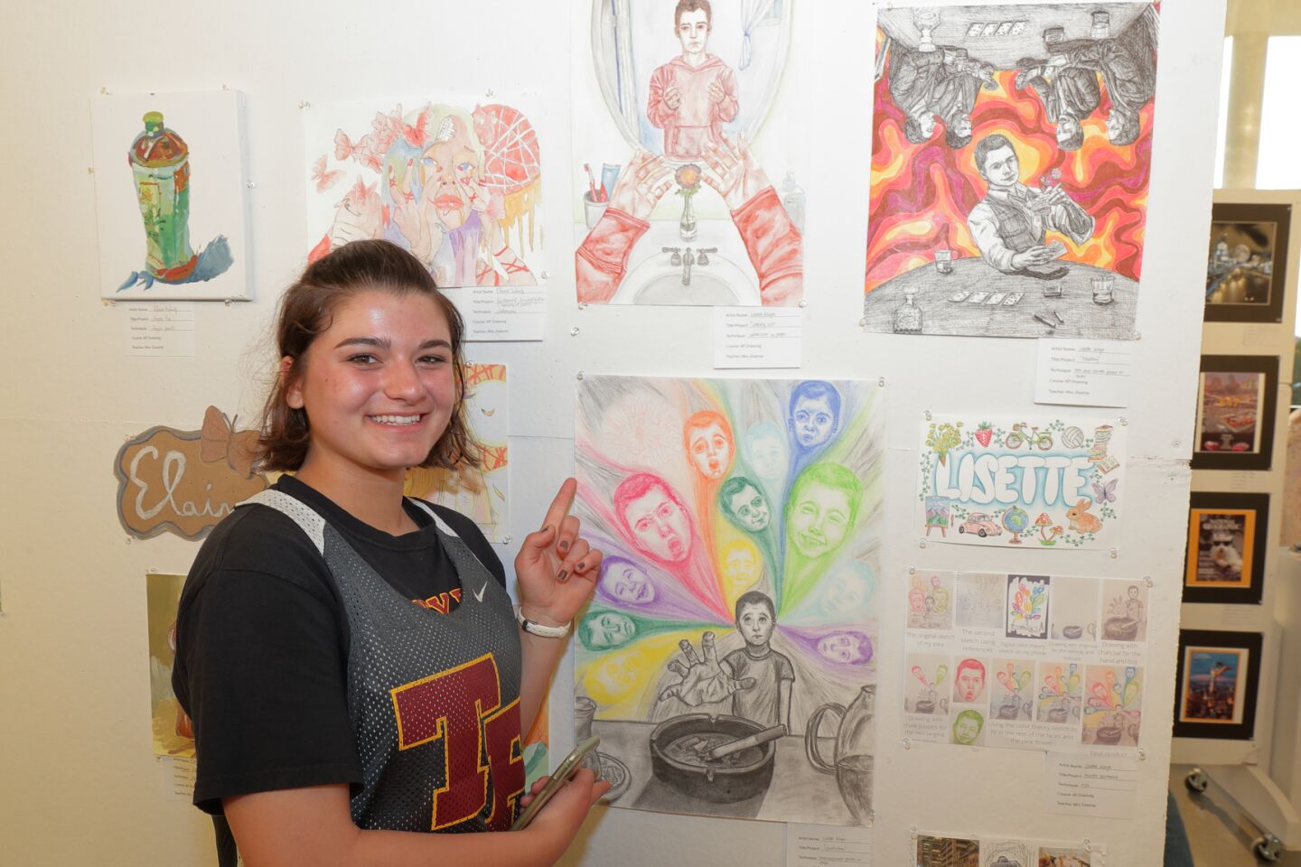 Lisette Kaya with several projects from her AP Drawing class