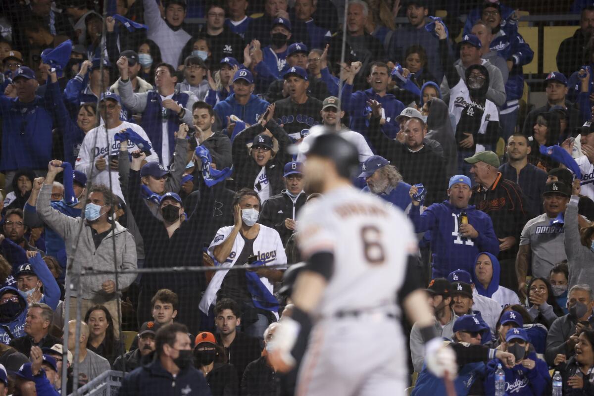 Dodgers fans cheer after San Francisco's Mike Yastrzemski strikes out during the second inning.