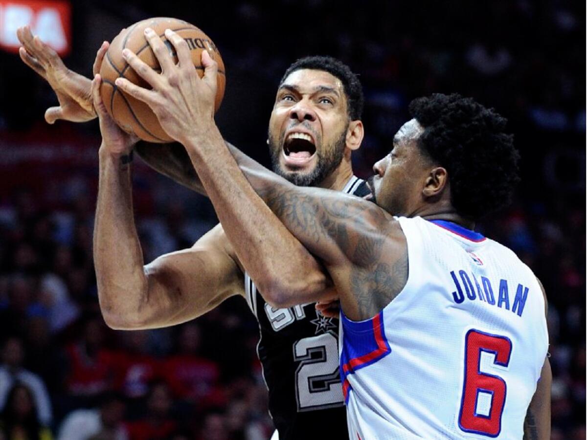 Spurs forward Tim Duncan is fouled by DeAndre Jordan while attempting a shot in the first quarter in Game 5 on the NBA basketball playoffs at the Staples Center.