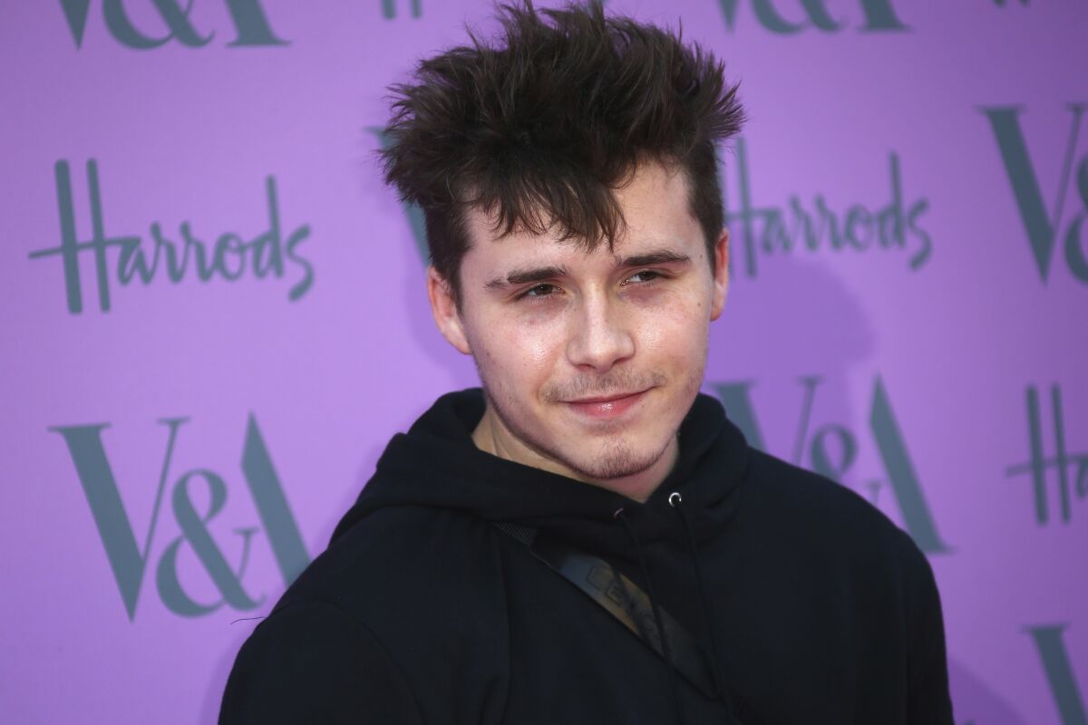 FILE - In this Wednesday, June 20, 2018 file photo, Brooklyn Beckham poses for photographers upon his arrival at the V & A Summer Party in London. Brooklyn Beckham, son of retired soccer superstar David Beckham and former Spice Girl Victoria Beckham, and American actress Nicola Peltz have announced that they're engaged. Beckham and Peltz both posted the news on their Instagram accounts on Saturday July 11, 2020. (Photo by Joel C Ryan/Invision/AP, File)